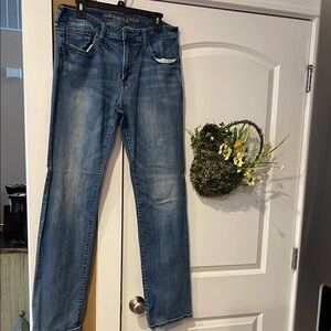 Size 34/36 Men's American Eagle distressed extreme flex bootcut Blue Jeans.